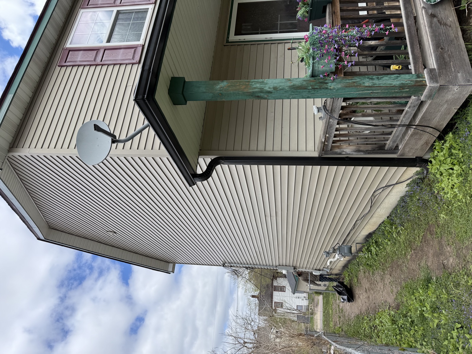 Home with new vinyl siding and deck