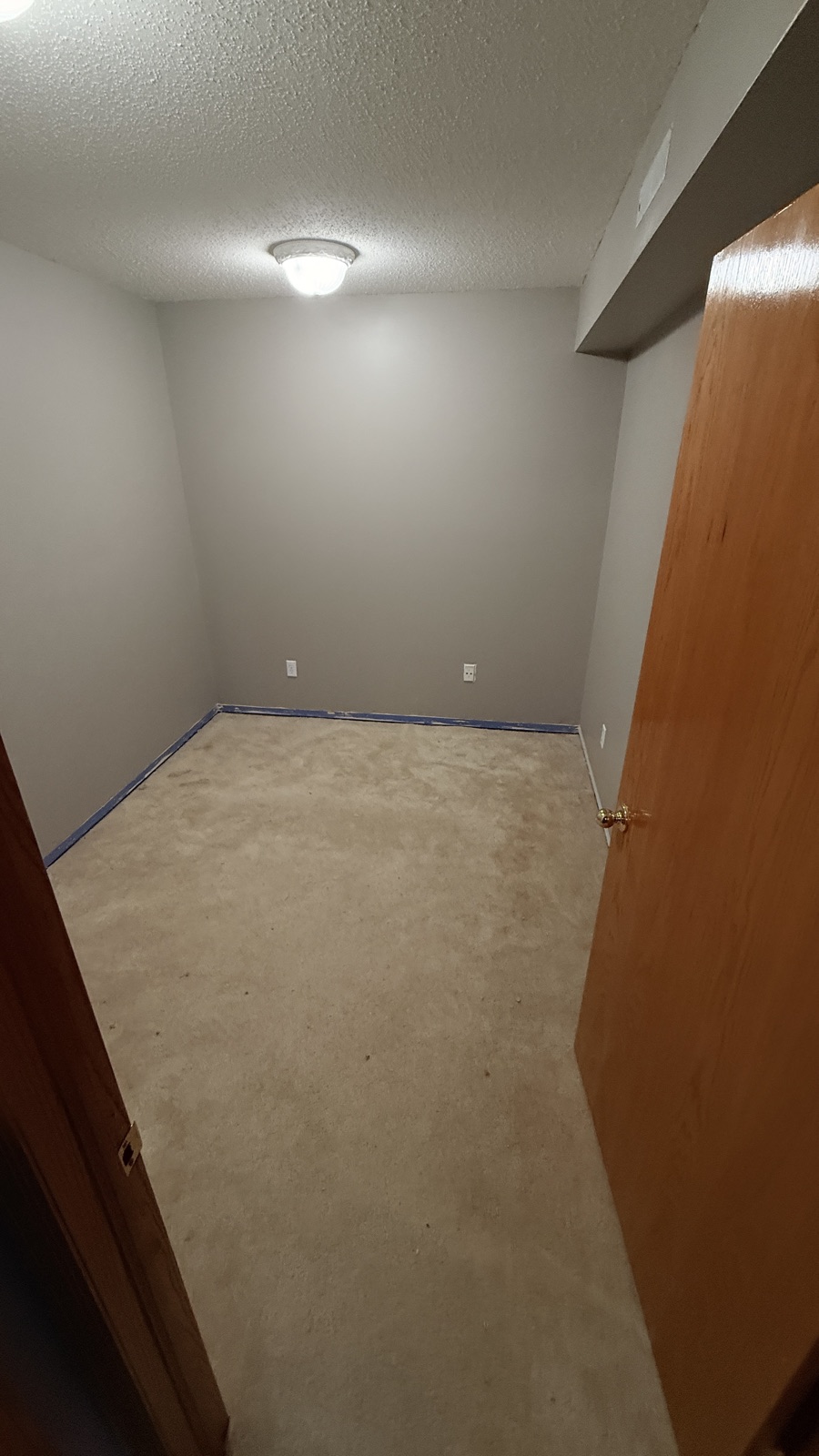 Bedroom stripped to the bare subfloor before new carpet