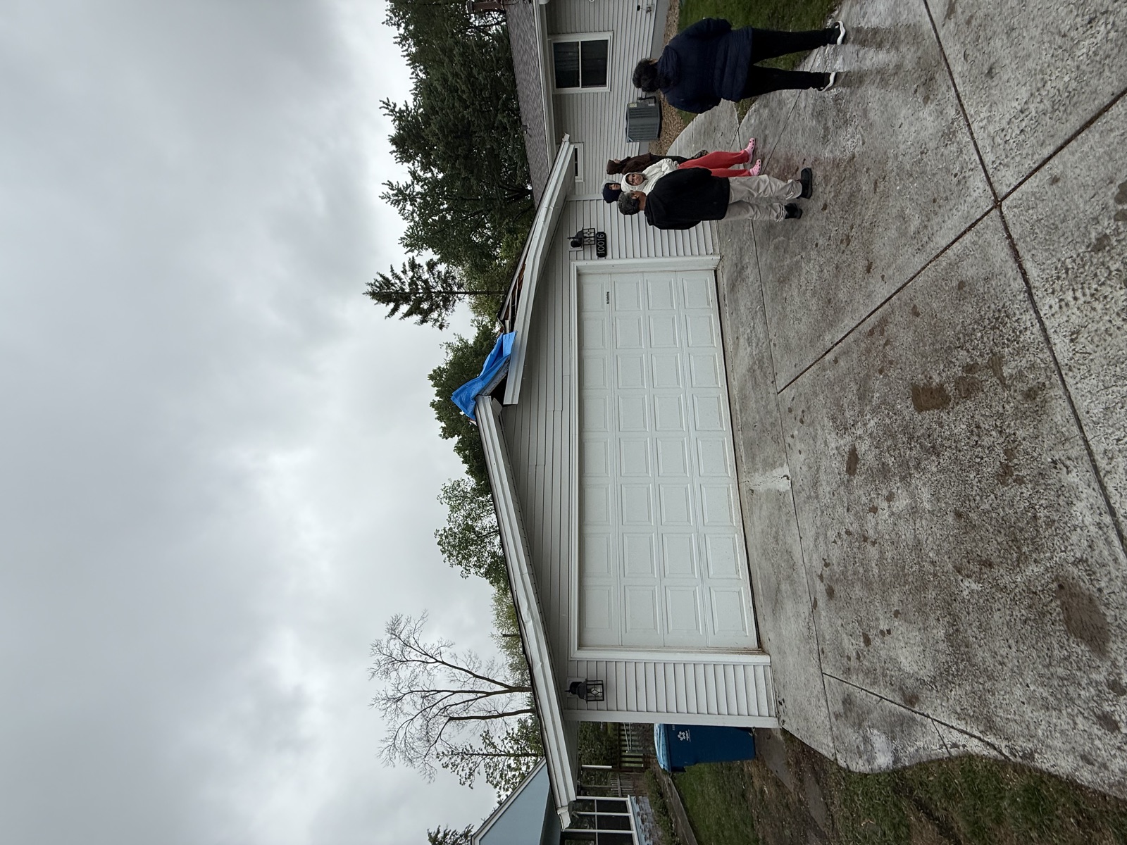 Storm-damaged garage roof tarped before repair