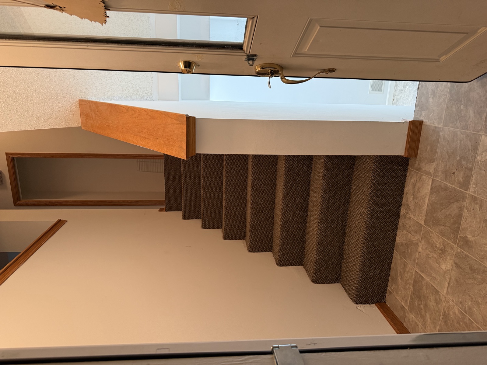 Finished carpeted staircase with new tile entry